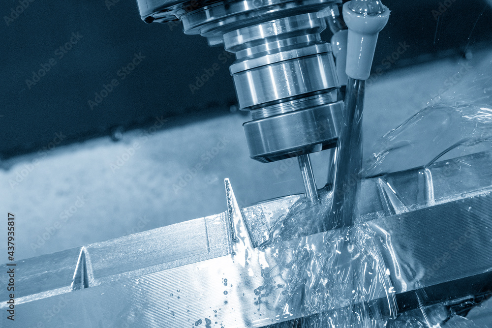 The CNC milling machine cutting the mold parts with oil coolant method. The mold and die manufacturing process by CNC machining center. The CNC milling machine cutting the mold parts with oil coolant method. The mold and die manufacturing process by CNC machining center.