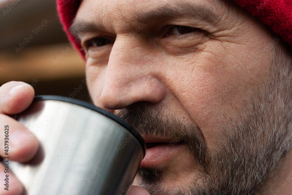 Closeup portrait of a man with beard drinking tea Closeup portrait of a man with beard drinking tea