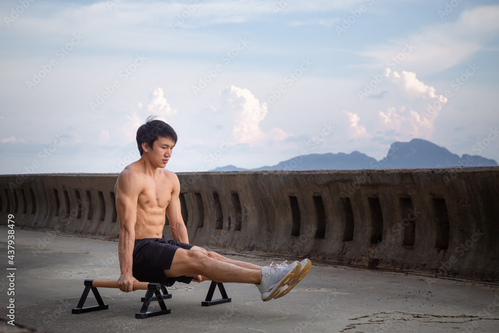 Young Asian man is doing street workout.bodyweight
