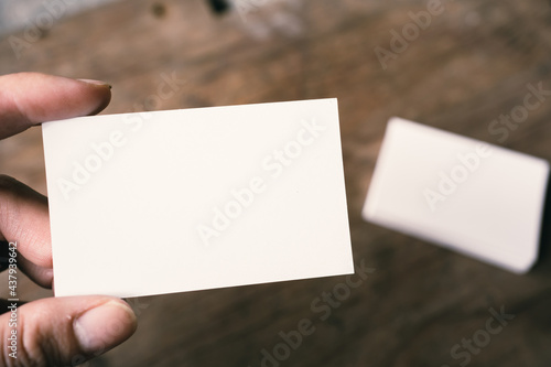 Pile of white blank space business name cards stack template for advertise and marketing on wooden texture background, clipping path for insert your banner text design for present the company brand