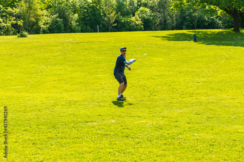Disc golf is a flying disc sport in which players throw a disc at a target; played using rules like golfs. Here a player is throwing from a fairway.