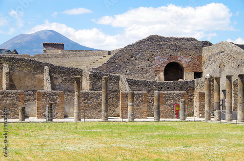 Famous landmark of ancient and historic city temple ruins with columns and walls on archeologic site museum Pompeji Pompeii excavation site in Italy near Naples and Vesuv Volcano photo