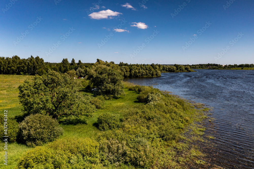 panoramic view from the drone to the village of a large lake and forest and fields and roads 