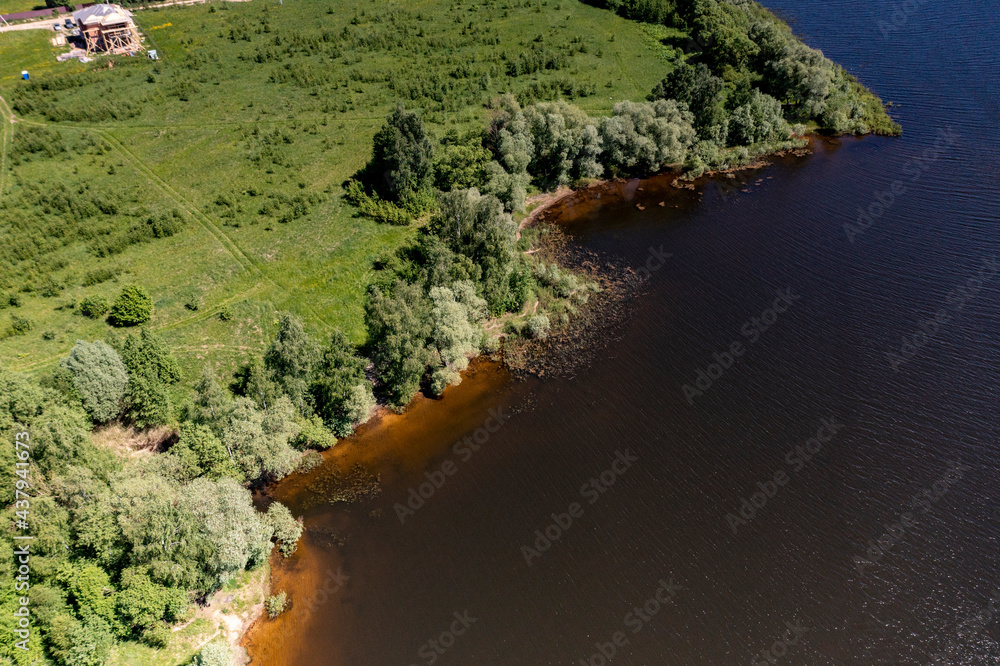 panoramic view from the drone to the village of a large lake and forest and fields and roads panoramic view from the drone to the village of a large lake and forest and fields and roads