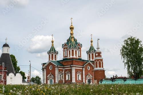 Cross-driven cathedral in Kolomna Kremlin from red bricks with golden domes. Russian Orthodox Church