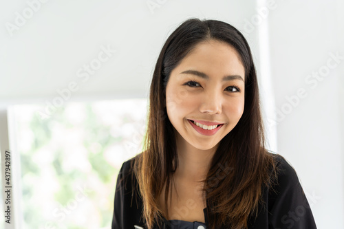 Free Download Close up of smiling Asian business woman at work in the office - GFXLoad