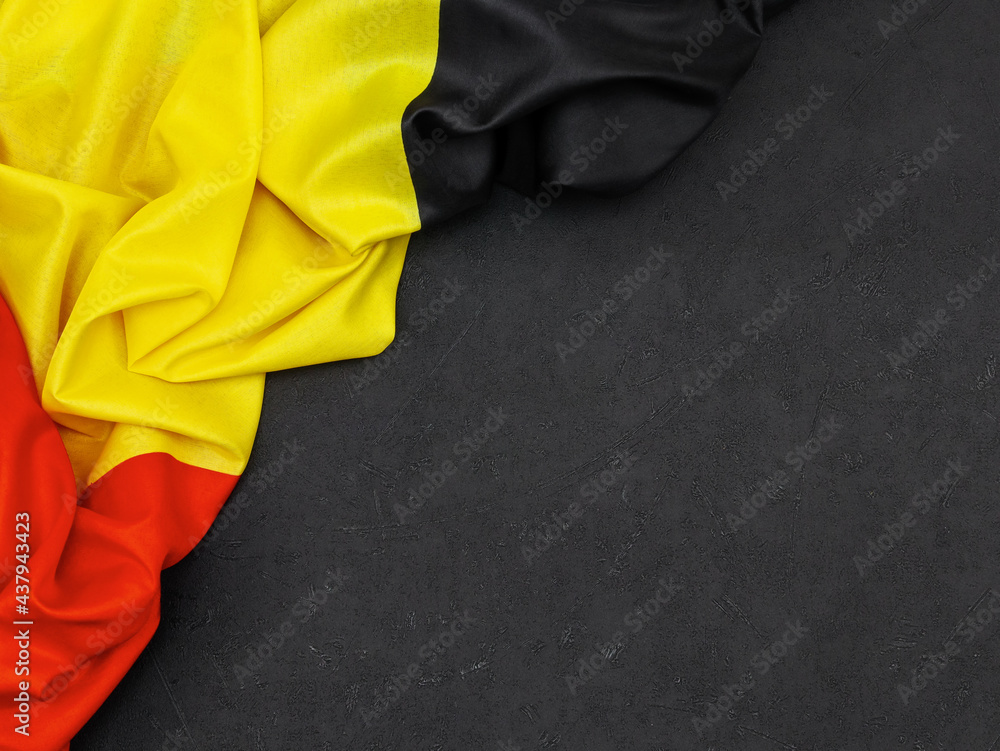 Belgian flag on black.
Belgian flag lies on the left on a black background with space for text to the right, top view close-up. Belgian flag on black.
Belgian flag lies on the left on a black background with space for text to the right, top view close-up.
