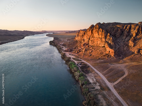 Drone shot of river and mountains at sunset in Kazakhstan