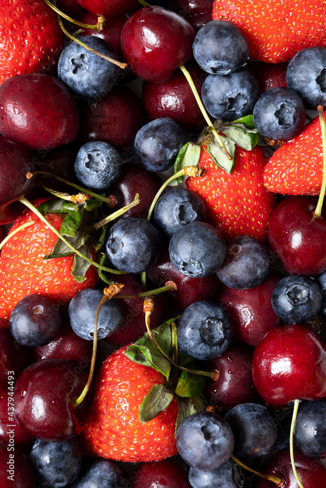 lots of strawberries, cherries and blueberries. juicy summer background with fruit lots of strawberries, cherries and blueberries. juicy summer background with fruit