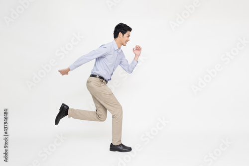 Young Asian businessman running forward isolated on white background © comzeal