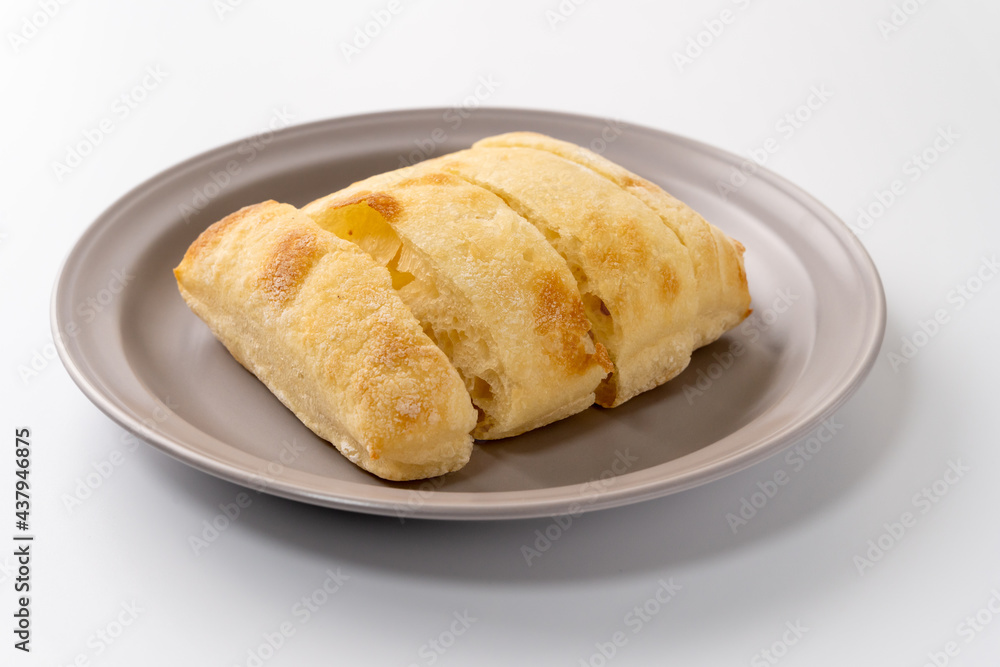 Freshly baked ciabatta bread is placed on a plate Freshly baked ciabatta bread is placed on a plate