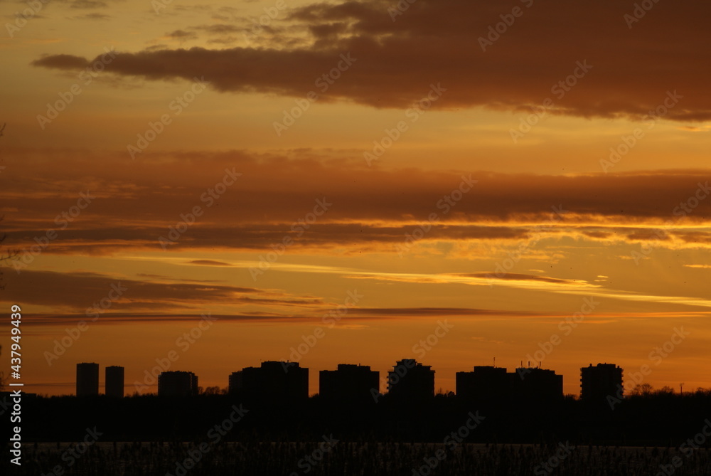 cloudy sunset over cityscape
