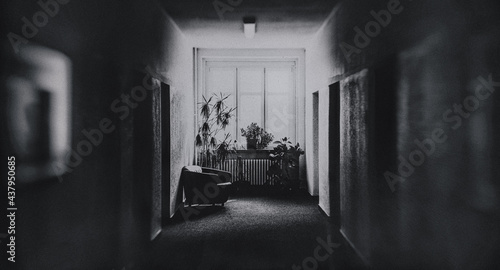 Ein dunkler Bürogang abgeschieden und düster als Symmetrie Fluchtpunkt Perspektive Fotografie - leeres, einsames Büro als schwarzweiss Horror Arbeitsplatz Schauplatz