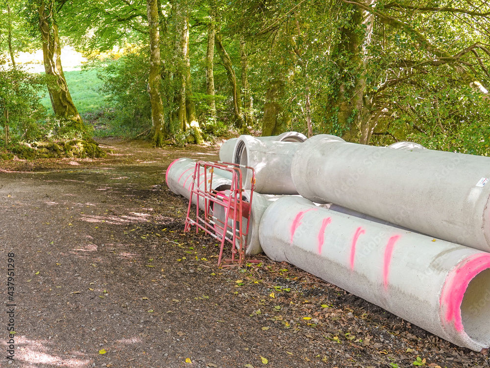 Sewer pipes on a forest road for the construction of a water drainage system. Sewer pipes on a forest road for the construction of a water drainage system.