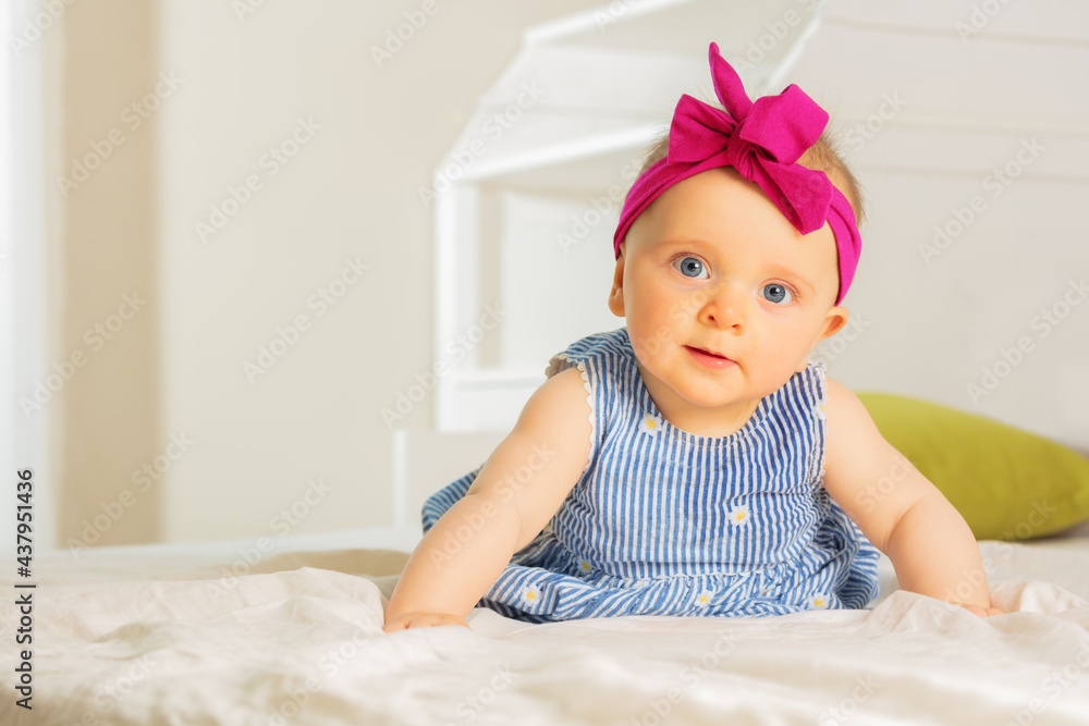Little infant baby girl in dress with red bow Little infant baby girl in dress with red bow