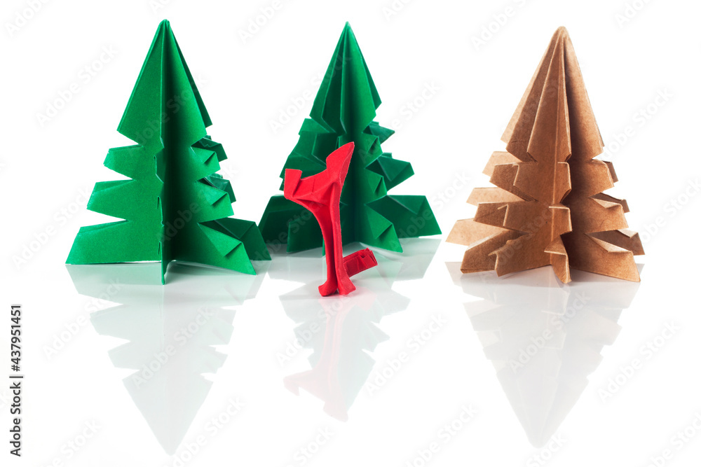 Fototapeta premium origami paper cat and trees over a white background.