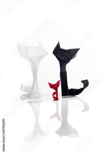 Origami cats over white background