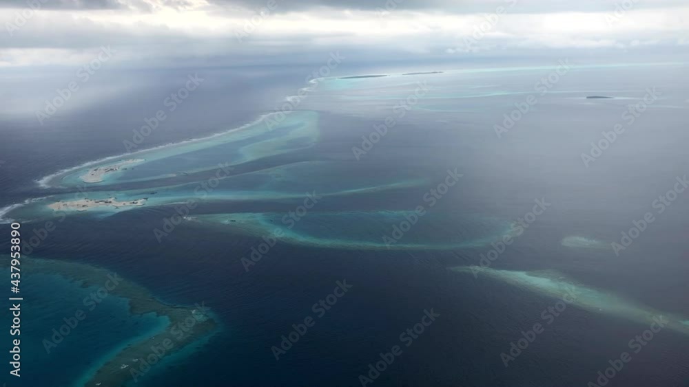 Aerial View of a Reef in Laccadive Sea in Maldives. Above Shot of Blue Indian Ocean. Aerial View of a Reef in Laccadive Sea in Maldives. Above Shot of Blue Indian Ocean.