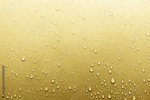 Water drops on golden surface, background