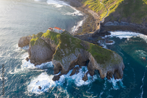Aerial view of the island and the Gaztelugatxe temple. Northern Spain in summer Manmade way to small isle on the Atlantic shore in Biscay region. Beautiful sunny morning.