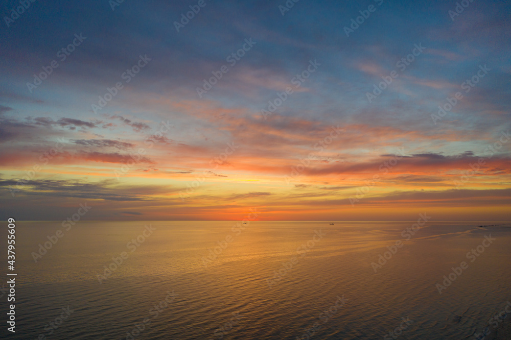 Aerial view of  beautiful orange sunset sky over sea