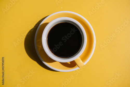 cup of coffee on yellow table