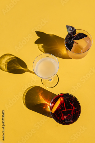 refreshment cocktails on the yellow table. top view with shadows