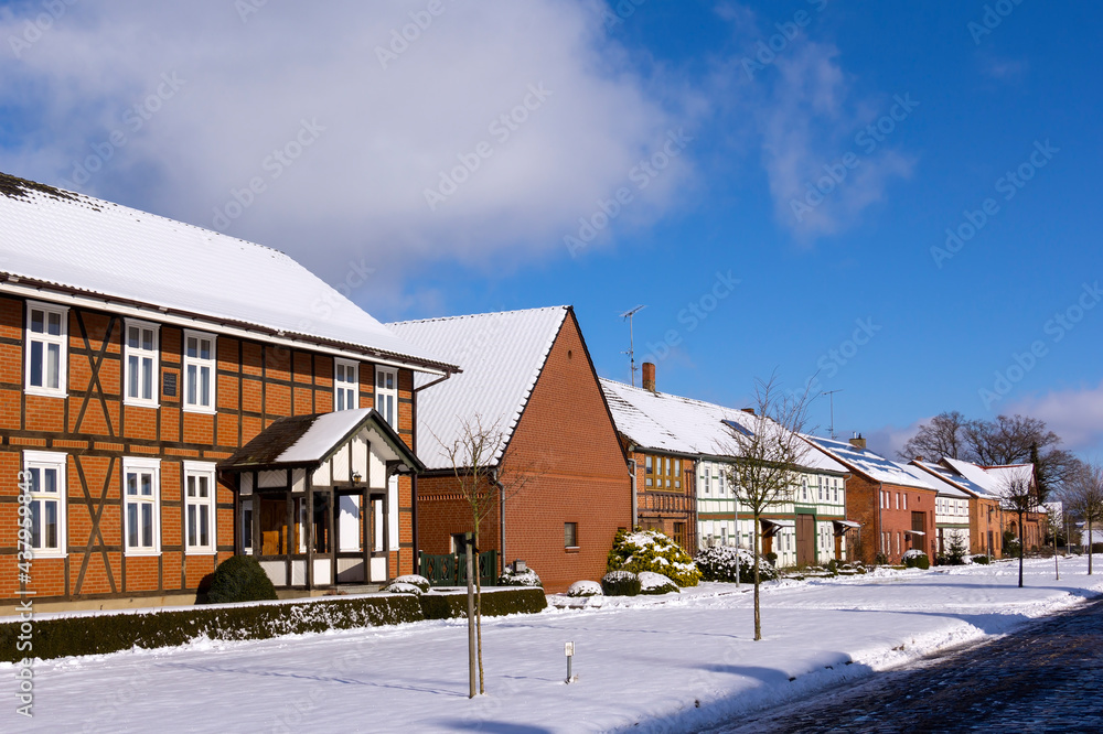 View into a small street of a typical village in the Altmark region in winter.