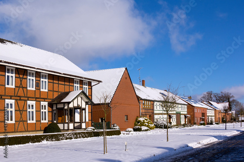 Obraz na płótnie View into a small street of a typical village in the Altmark region in winter. w salonie