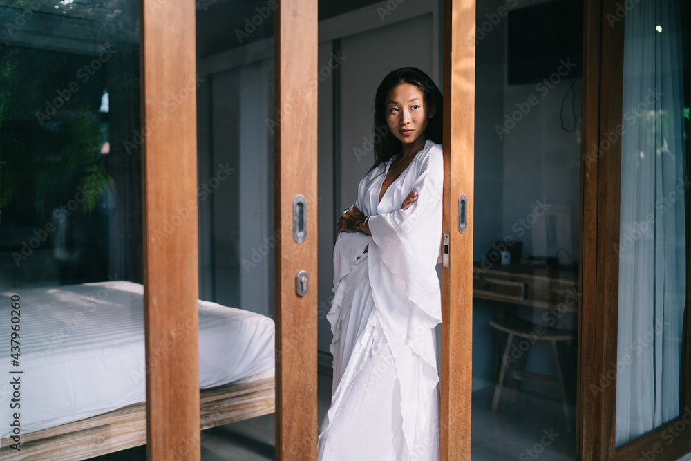 Calm Asian woman resting in hotel Calm Asian woman resting in hotel