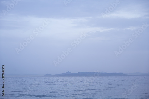 Beautiful landscape of Aegean sea in Athens at cloudy day. Silhouettes of islands in the mist. Nobody. Greece.