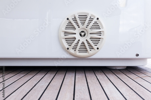 A music speaker integrated into the sofa body on the teak deck of a luxury yacht.