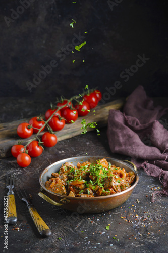 Photography Roast beef offal served on dark background