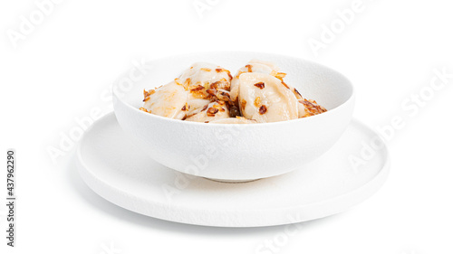 Dumplings with potatoes and fried onions in white plate isolated on a white background.