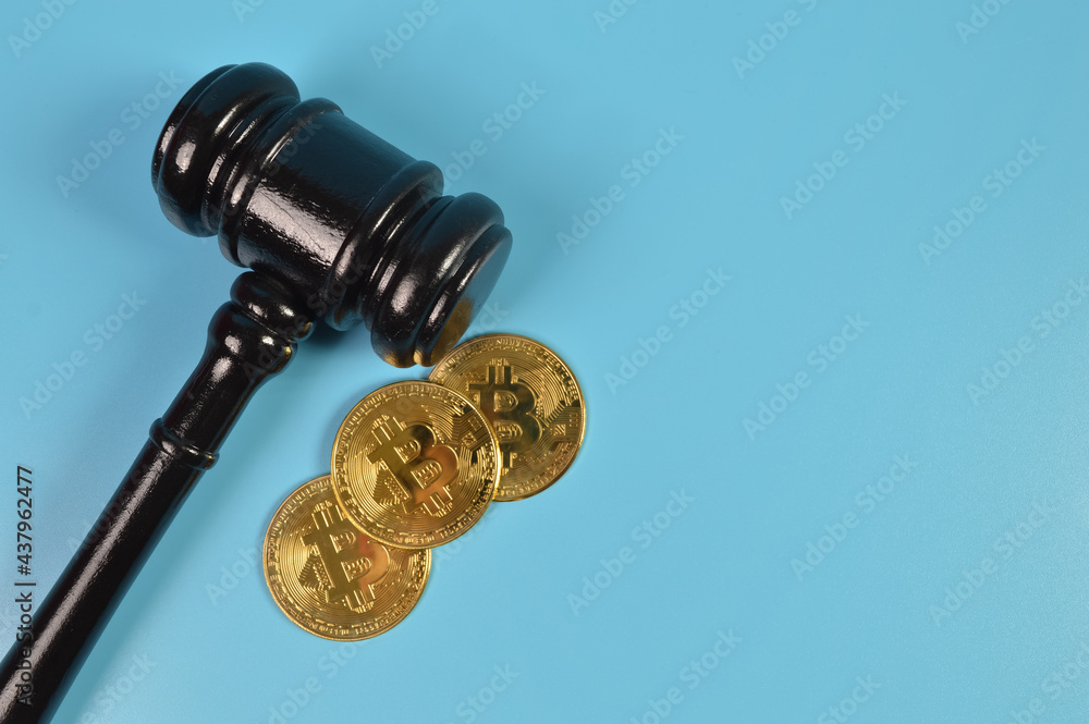 Top view of judge gavel and golden bitcoins with copy space