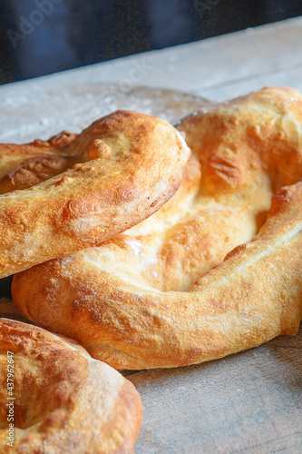 Armenian national matnakash bread. Part view of three loaves of bread on kitchen table
