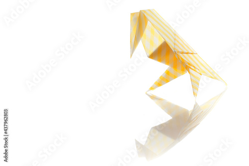 Origami bird made of colored paper isolated on white background