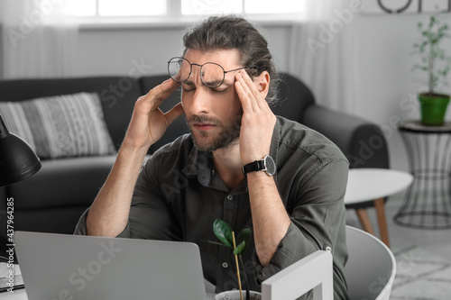 Tired young man working in ...