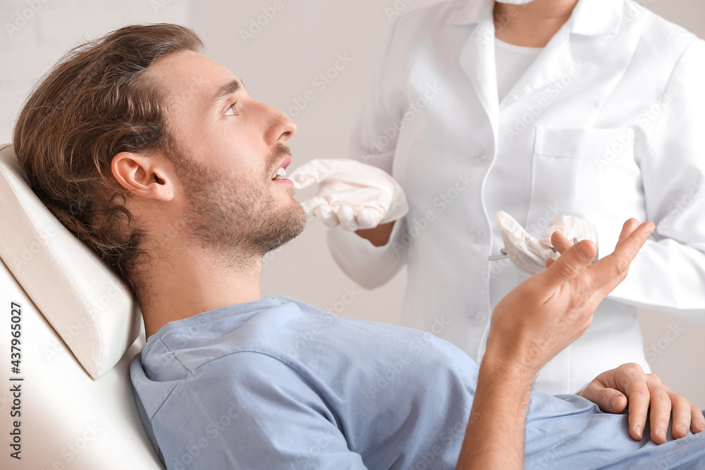 Young man visiting dentist in clinic Young man visiting dentist in clinic