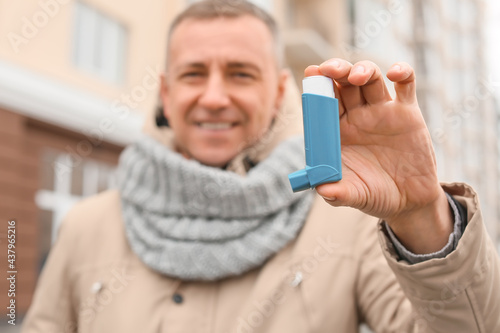 Senior man with inhaler out...