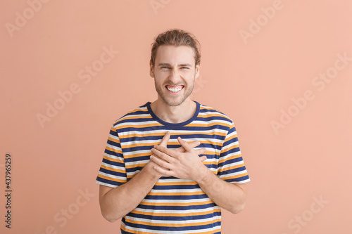Smiling young man on color ...