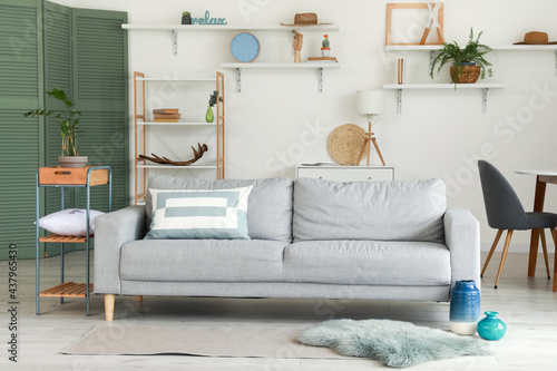 Stylish interior of living room with cozy sofa