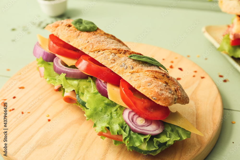 Obraz premium Tasty ciabatta sandwich on color wooden background