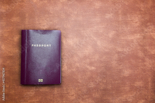 top view image of blank Passport on brown leather background texture with copy space, travel,tourist,document,indentification concept modern design