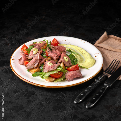 Potato, beef steak, romano and vegetable salad on a wooden background, top view. Balanced diets healthy food