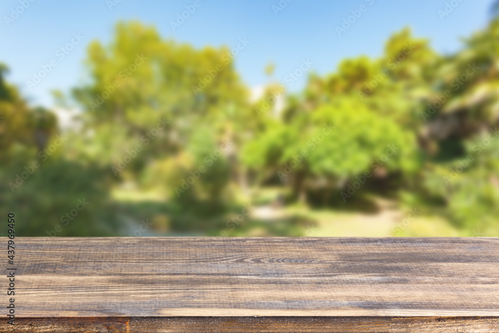 wood table top on blur trees and sky background wood table top on blur trees and sky background