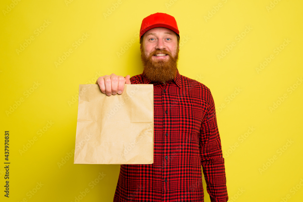 Delivery man with hat and beard has an happy expression Delivery man with hat and beard has an happy expression