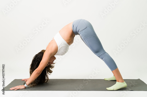 Practicing a yoga pose on an exercise mat