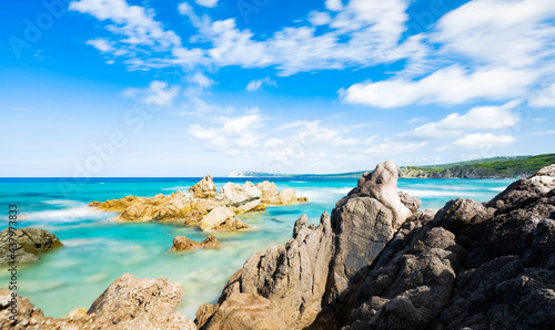Fototapeta Naklejka Na Ścianę i Meble -  (Long exposure) Stunning view of a rocky coastline bathed by a turquoise, clear sea during a sunny, summer day, Rena Majore, Sardinia, Italy.