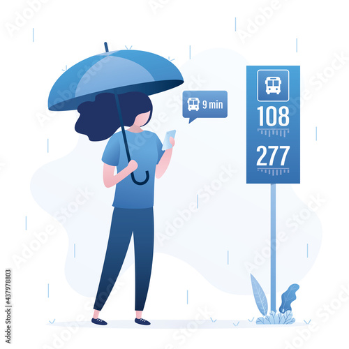 Cute girl stands at bus stop and waits for bus. Placard with bus numbers and schedule. It's raining, woman is holding umbrella. Female character use cell phone.